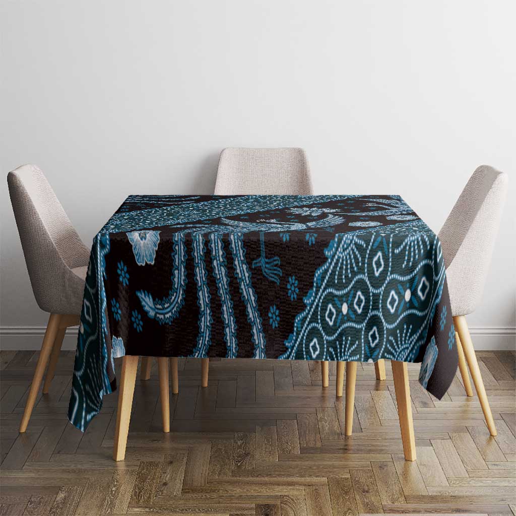 Blue batik-pattern tablecloth draped over dining table, dark navy teal geometric motifs