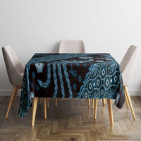 Blue batik-pattern tablecloth draped over dining table, dark navy teal geometric motifs