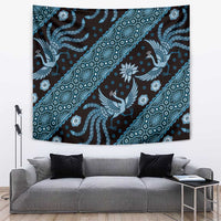 Blue batik pattern tapestry with diagonal bird and floral motifs on dark background