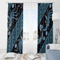 Blue batik-pattern curtain panels with rod top above sheer white panels