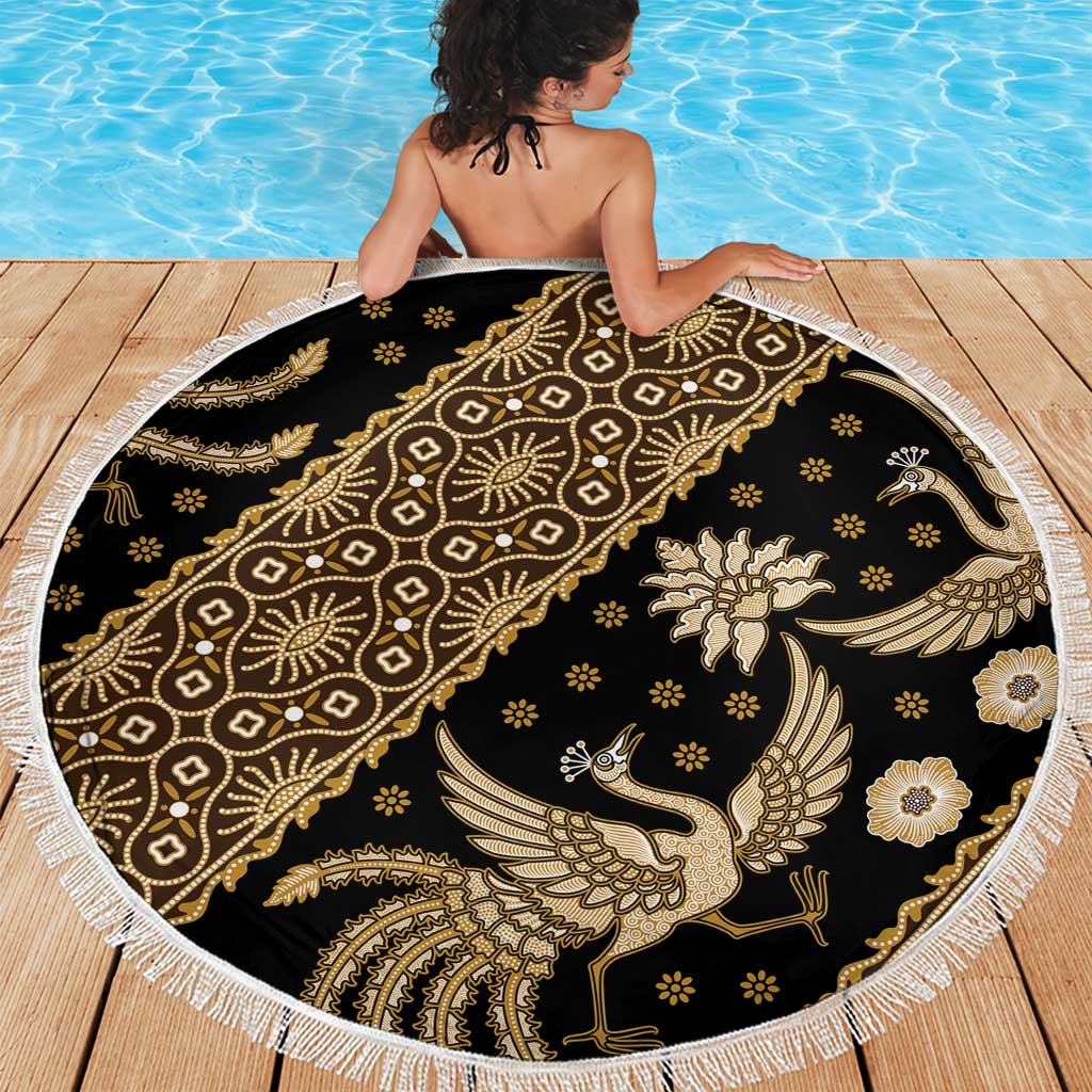 Round batik beach blanket with dark black background, gold bird floral motifs, white tassel edge