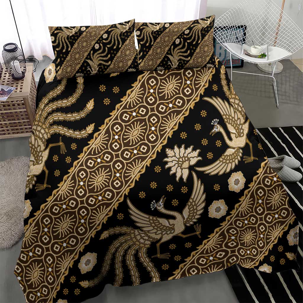 Batik bedding set close-up showing dark fabric and gold batik pattern with bird figures