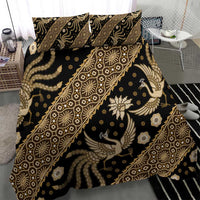 Batik bedding set close-up showing dark fabric and gold batik pattern with bird figures