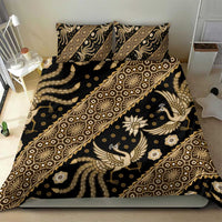 Batik bedding set on bed with dark base and gold ornamental batik pattern, duvet and pillows