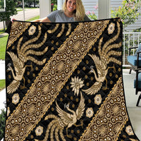Batiki-style quilt featuring gold, beige, and cream ornate figures and diamond patterns on black
