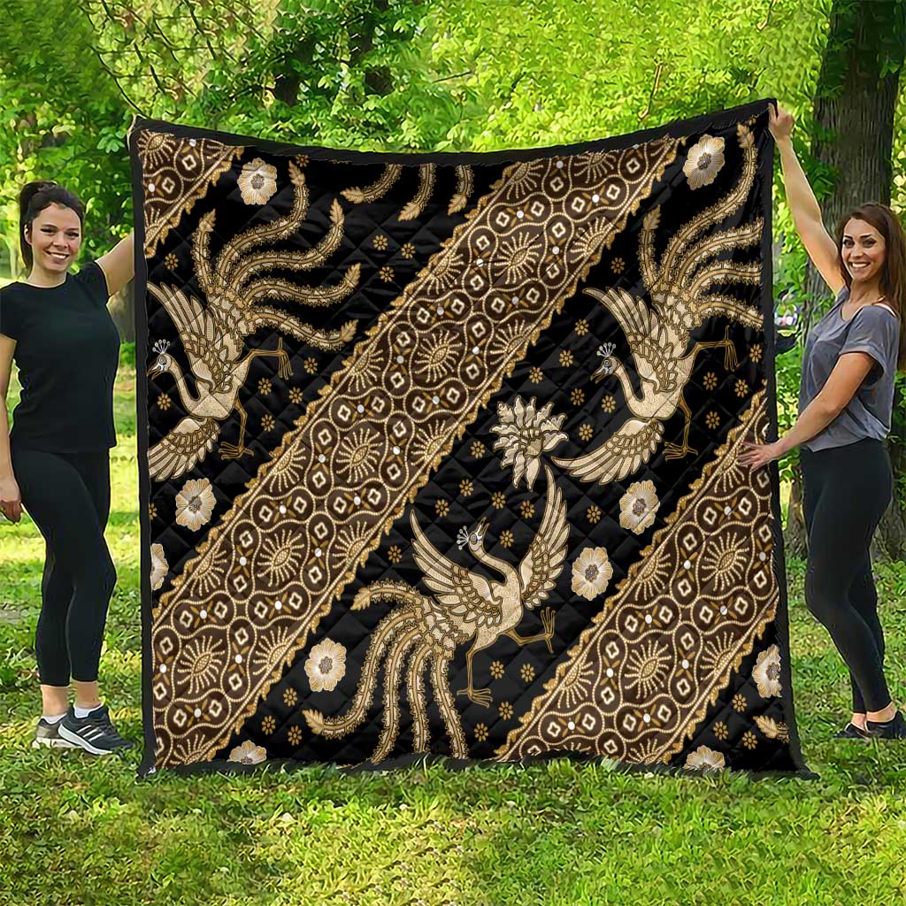 Gold and beige batik-style pattern quilt with ornate animal and floral motifs on dark fabric