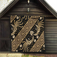Batik pattern quilt with gold and beige dragon-like figures and floral details on dark fabric