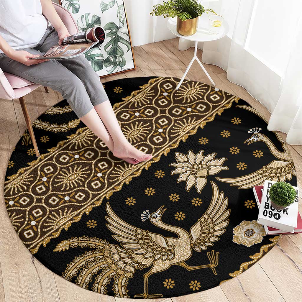 Round batik pattern carpet, dark with gold bird motif and ornate diamond medallions