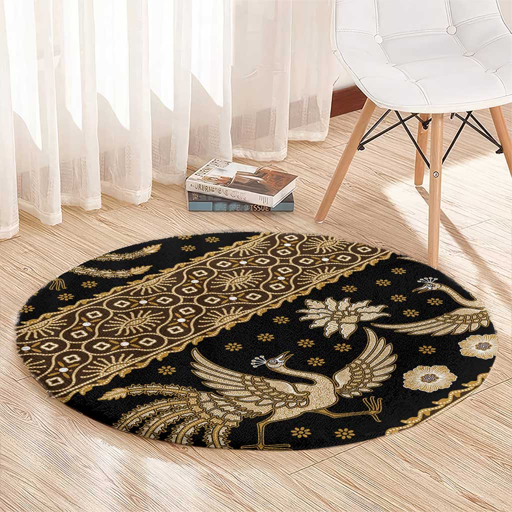 Round batik pattern carpet, dark with gold bird winged emblem and geometric border