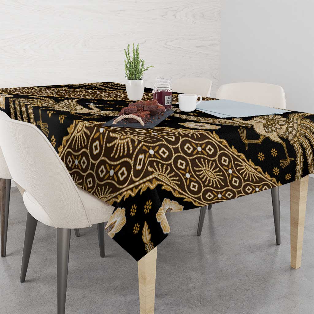 Batik tablecloth with dark base and gold floral and geometric patterns, dining setting