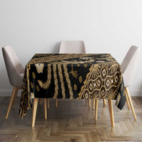 Batik tablecloth draped on dining table, dark fabric with gold geometric and floral motif