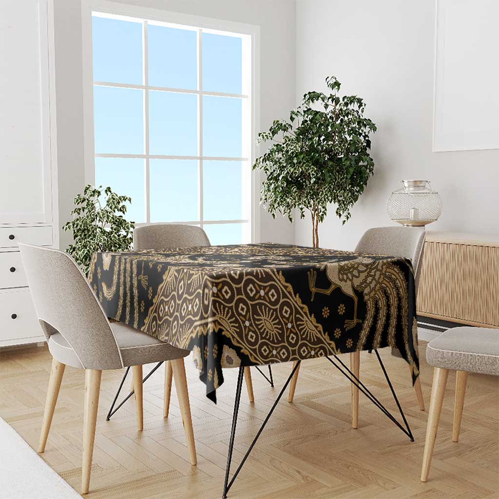 Batik tablecloth on dining table, dark fabric with gold ornate patterns and border stripes
