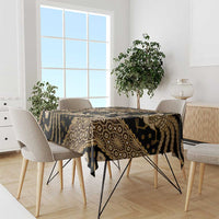 Batik tablecloth on dining table, dark fabric with gold ornate patterns and border stripes