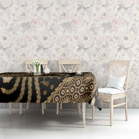 Batik tablecloth with black background and gold leaf, bird, and diamond patterns
