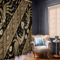 Black and gold batik-pattern curtain panels with detailed swirling bird and floral motifs.