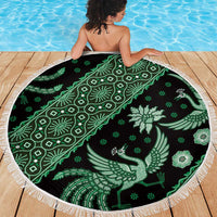 Round green batik-pattern beach blanket with white fringed edge, bird and floral motifs
