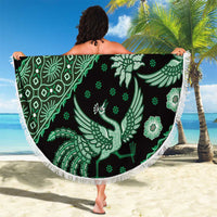 Round green batik-pattern beach blanket with white fringe, peacock and flower motifs
