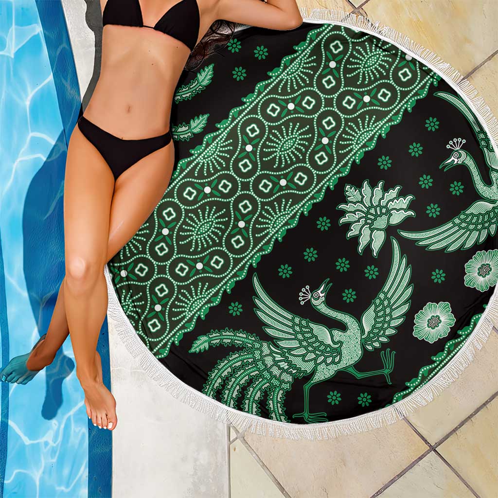 Round green batik-pattern beach blanket with white fringed edge, peacock bird design