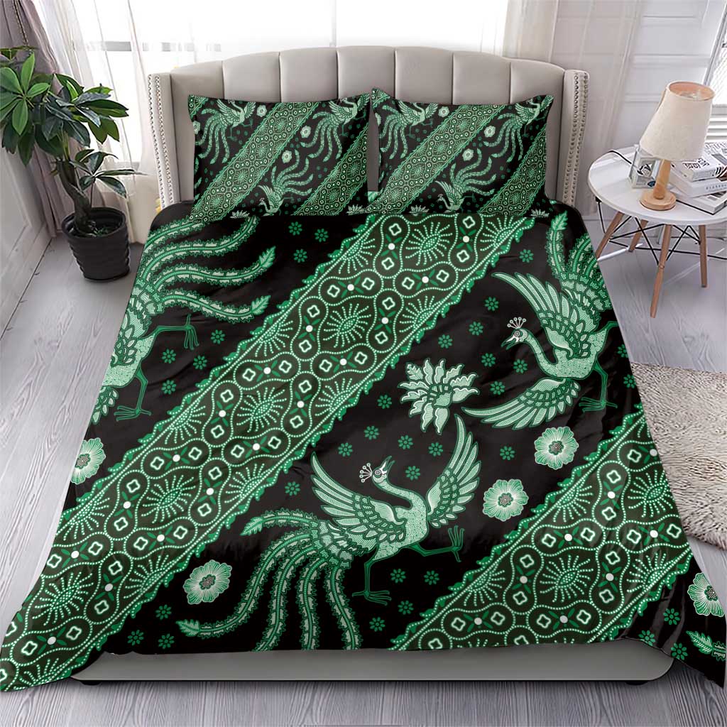 Green batik patterned bedding set with duvet cover and two pillowcases on a bed.