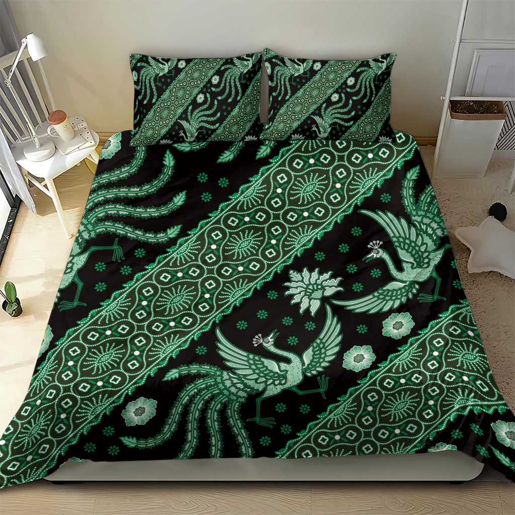 Green batik patterned bedding set with matching pillowcases, dark base with light motifs.