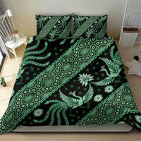 Green batik patterned bedding set with matching pillowcases, dark base with light motifs.