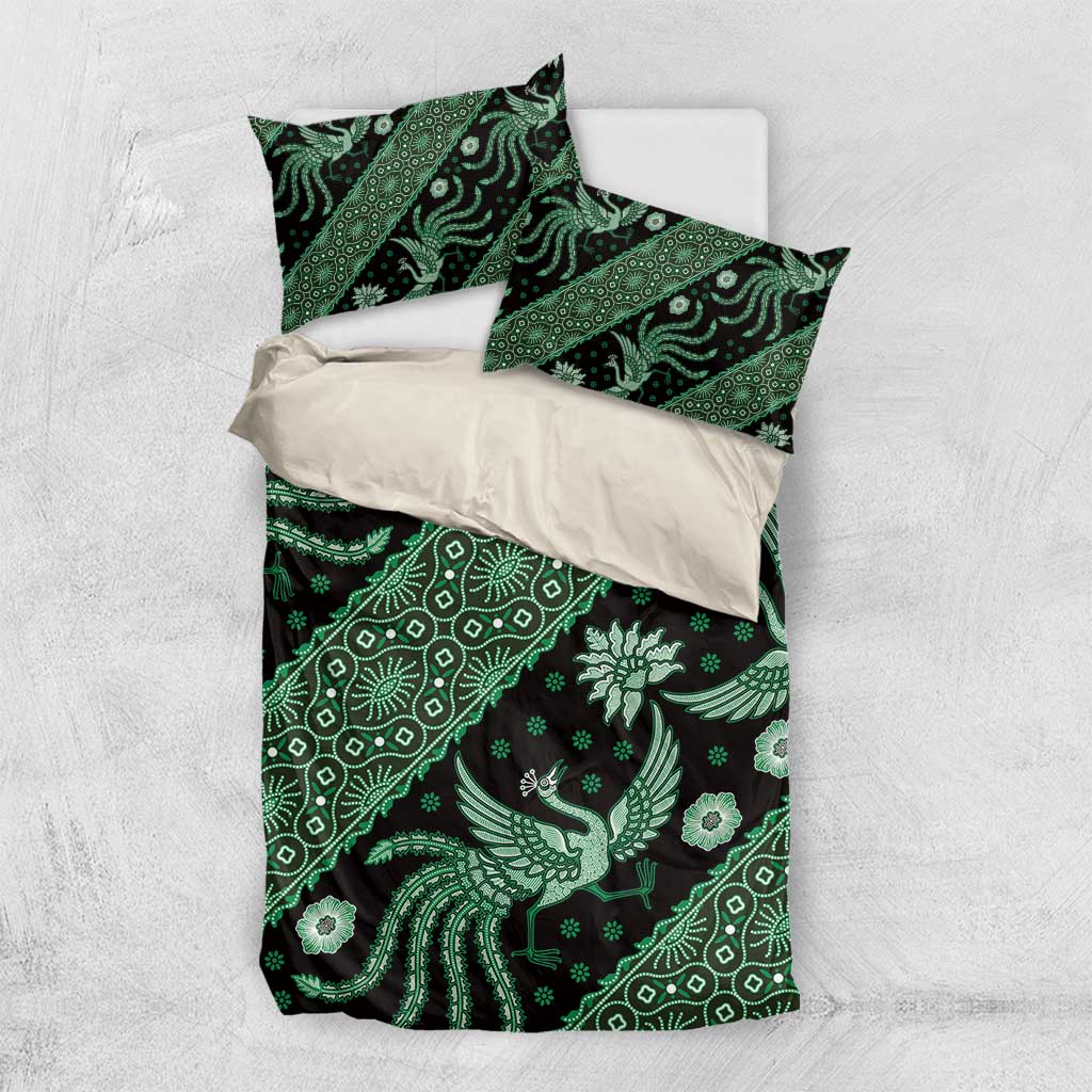 Green batik bedding set showing duvet cover and two pillowcases with dark floral motifs.