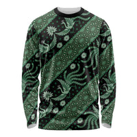Green batik long-sleeve crewneck shirt with geometric bands and birds, black base