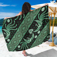 Green batik pattern sarong with white ornate motifs, draped wide fabric