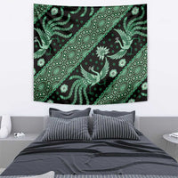Green and black batik tapestry with diagonal line of bird and flower motifs and ornaments.