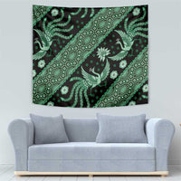 Green bird and floral batik tapestry with repeating geometric medallion shapes on dark base.
