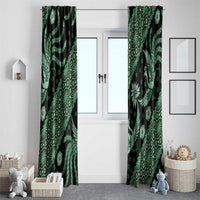 Green batik-pattern window curtains with matching panels, ornate bird and leaf designs on dark fabric