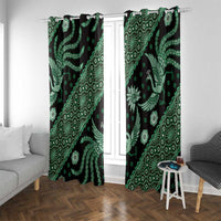 Green batik-pattern window curtain panels with bird and geometric motifs on dark fabric