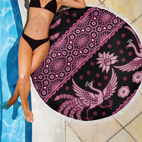 Round batik beach blanket with pink and white bird motifs and geometric lines, fringed edge.