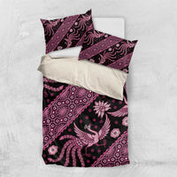 Flat lay of pink and purple batik bedding set with duvet cover and pillowcases