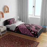 Pink batik pattern bedding set on bed with duvet cover and two matching pillowcases