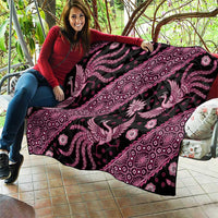 Pink and black batik-pattern quilt with large peacock and floral medallion design.
