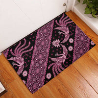 Pink batik-pattern rubber doormat showing diagonal stripe with bird and floral motifs