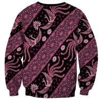 Unisex crewneck sweatshirt with pink batik-style pattern and long sleeves