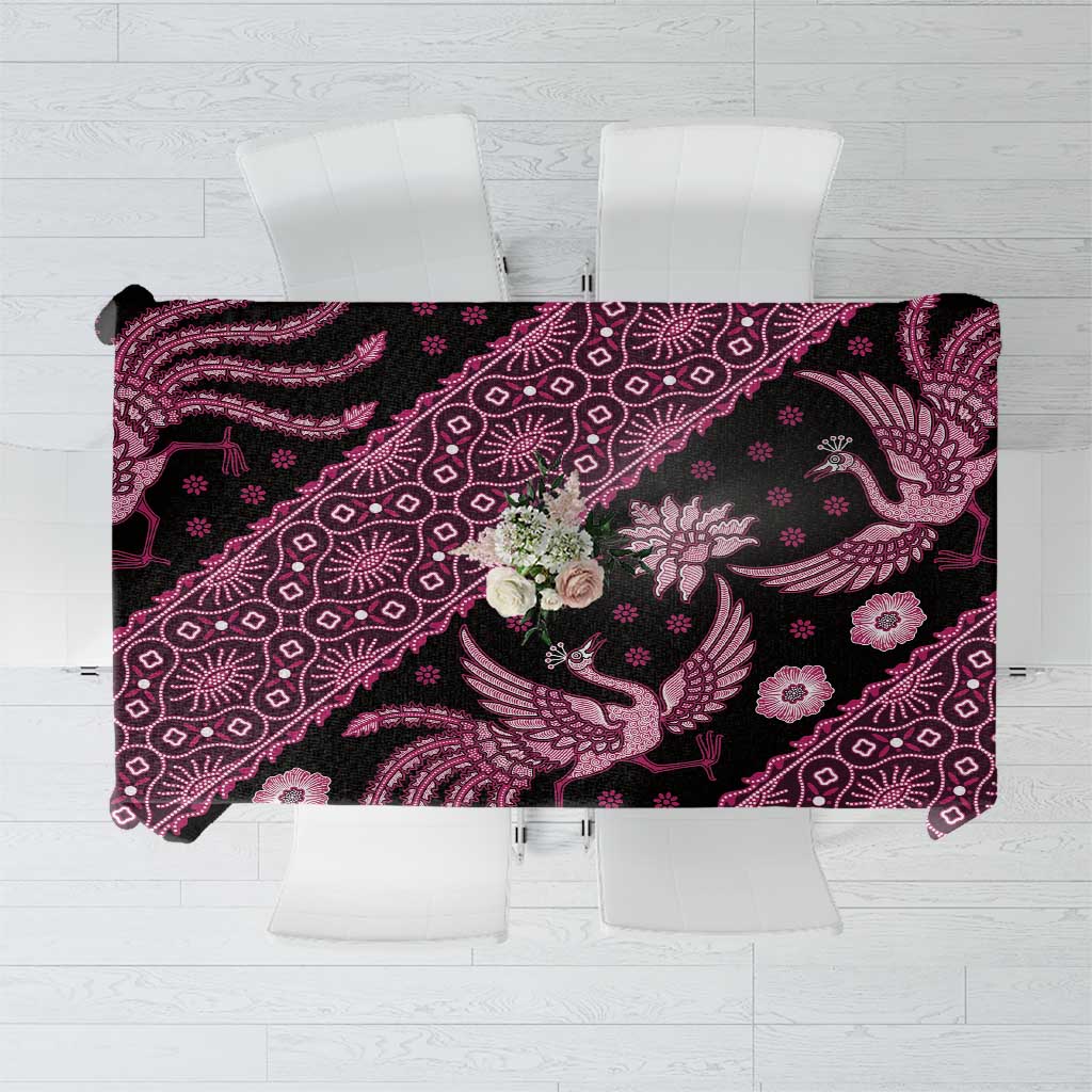 Batik tablecloth with dark base and pink floral and paisley pattern, rectangular hem.