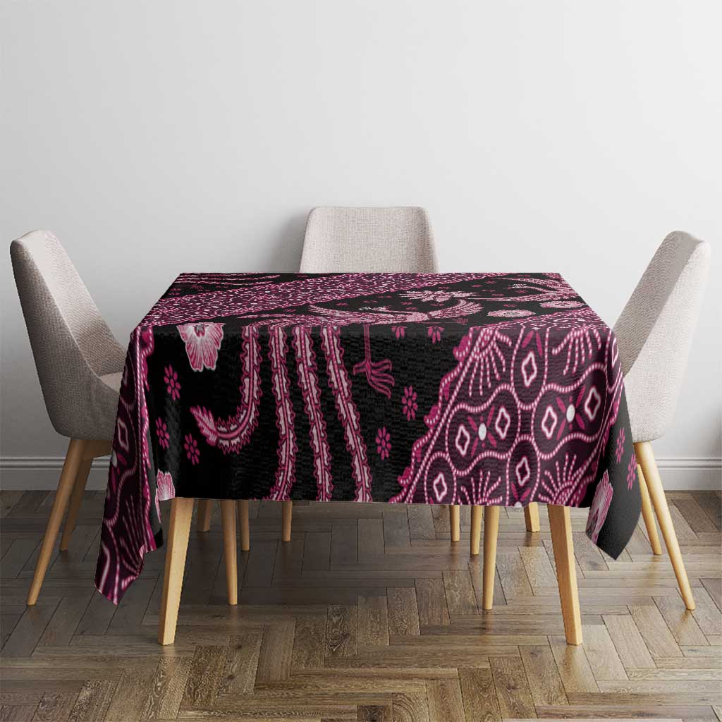 Batik tablecloth on table with chair backs, dark fabric with pink batik patterns.