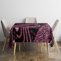 Batik tablecloth on table with chair backs, dark fabric with pink batik patterns.