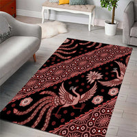 Red batik-pattern area rug with bird and ornamental motifs on a dark base.