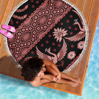 Round batik beach blanket with red floral and bird motifs on dark base, white fringe
