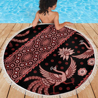 Round batik beach blanket with red bird and floral motifs, dark fabric and white fringe