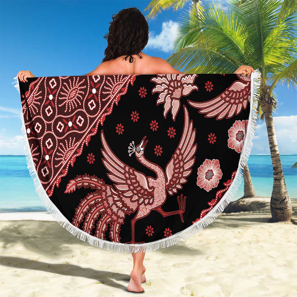 Round batik beach blanket with dark fabric, red bird motifs, and white fringe edging