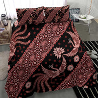 Batik bedding set on bed with red-and-black duvet and two pillowcases, ornamental motifs