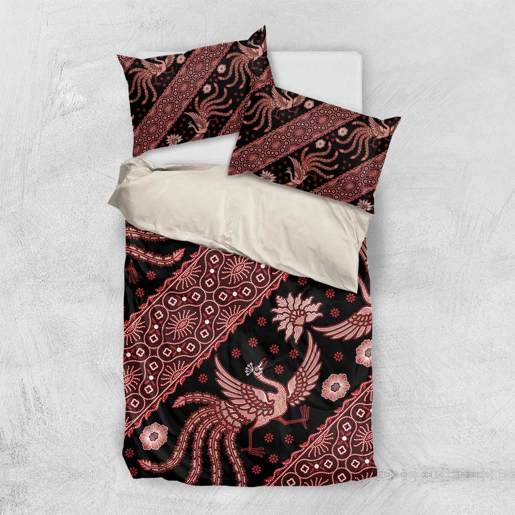Batik bedding set laid flat: red-and-black duvet with two matching patterned pillowcases