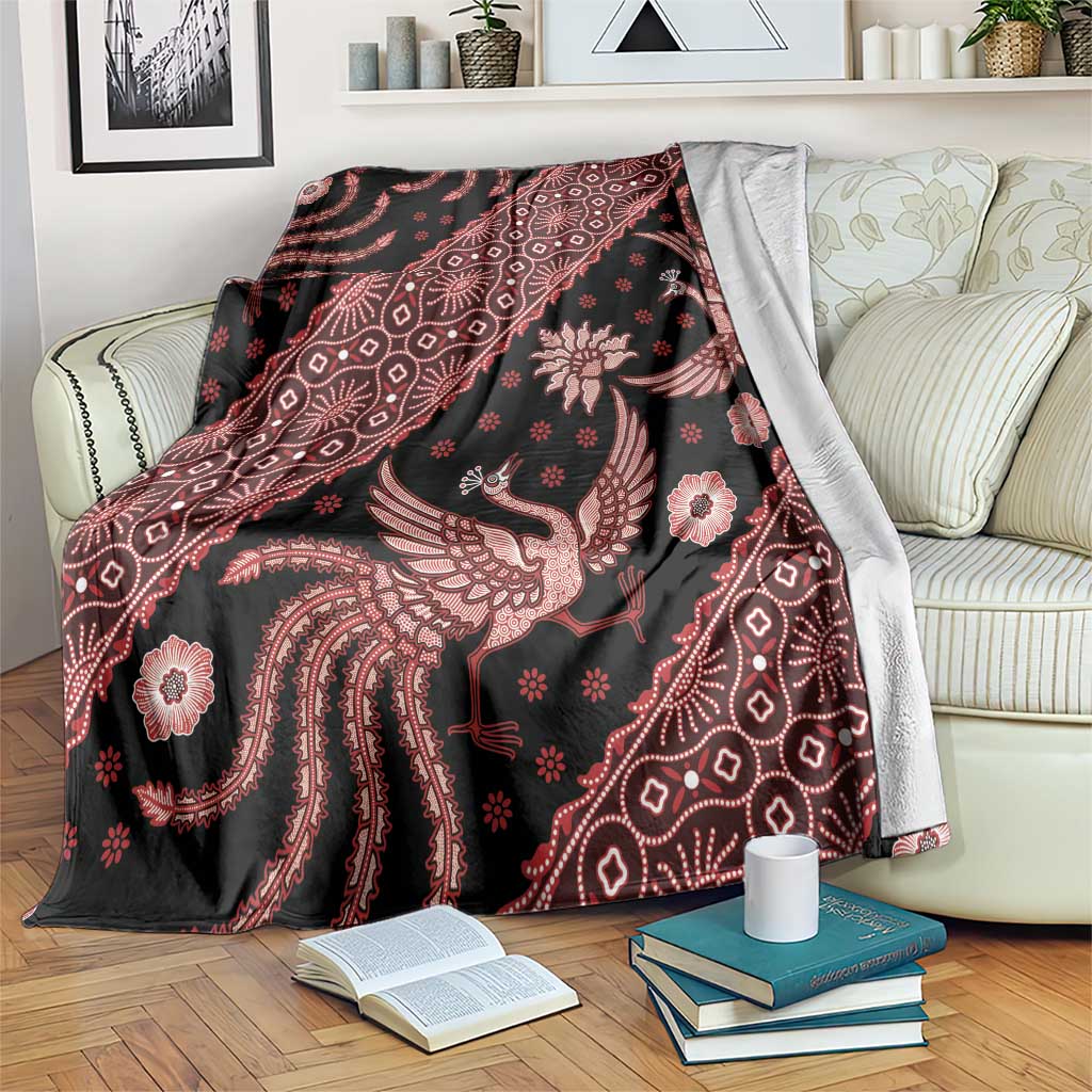 Batik-pattern blanket with dark background and red bird, floral, and geometric motifs