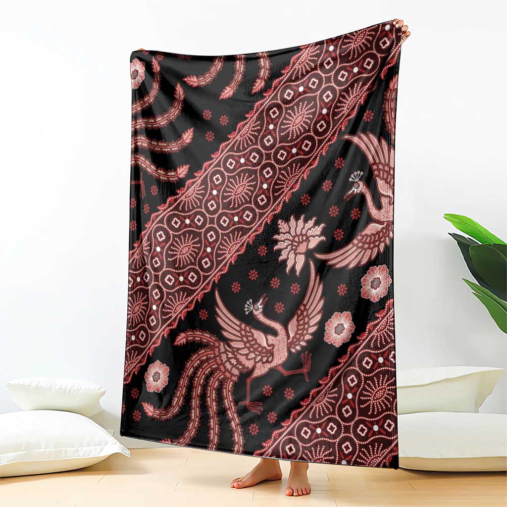Batik-pattern blanket with dark base and red floral and bird motifs