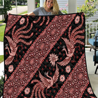 Large red and black batik pattern quilt with floral and animal motifs, full view